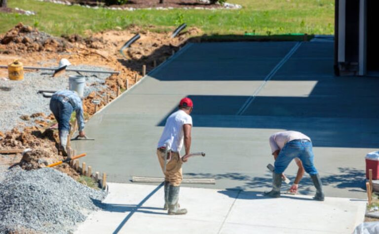 Residential driveway renovation with concrete workers