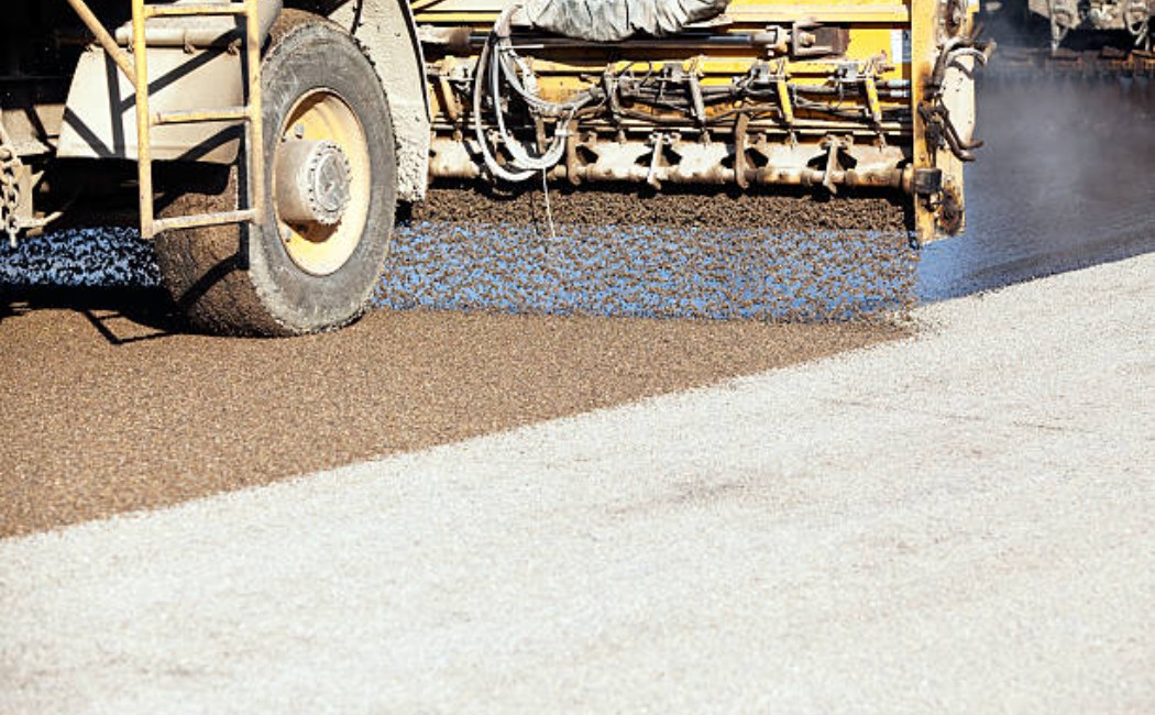 Tar and chip road surfacing in progress on a residential street