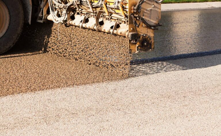 Street resurfacing using the tar and chip sealing method