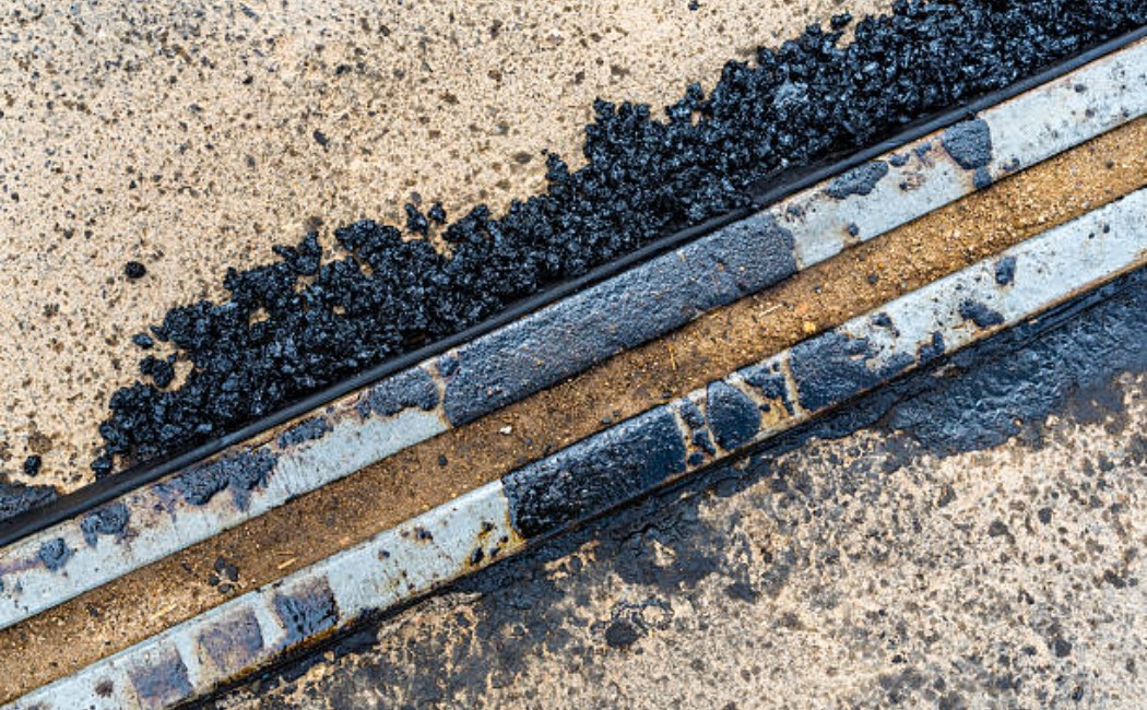 Close-up of fresh, grainy asphalt surface on a road