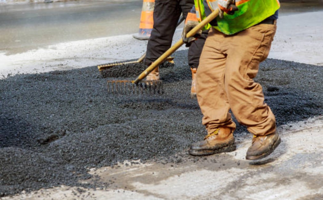 Road resurfacing with new black asphalt.