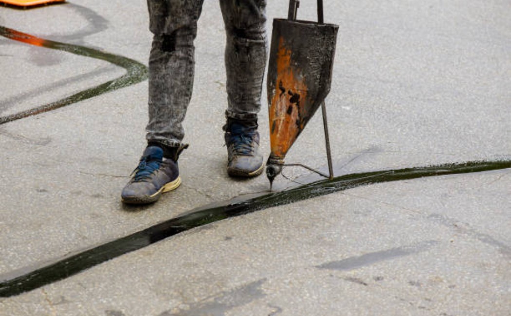 Filling pavement cracks with hot asphalt sealant material