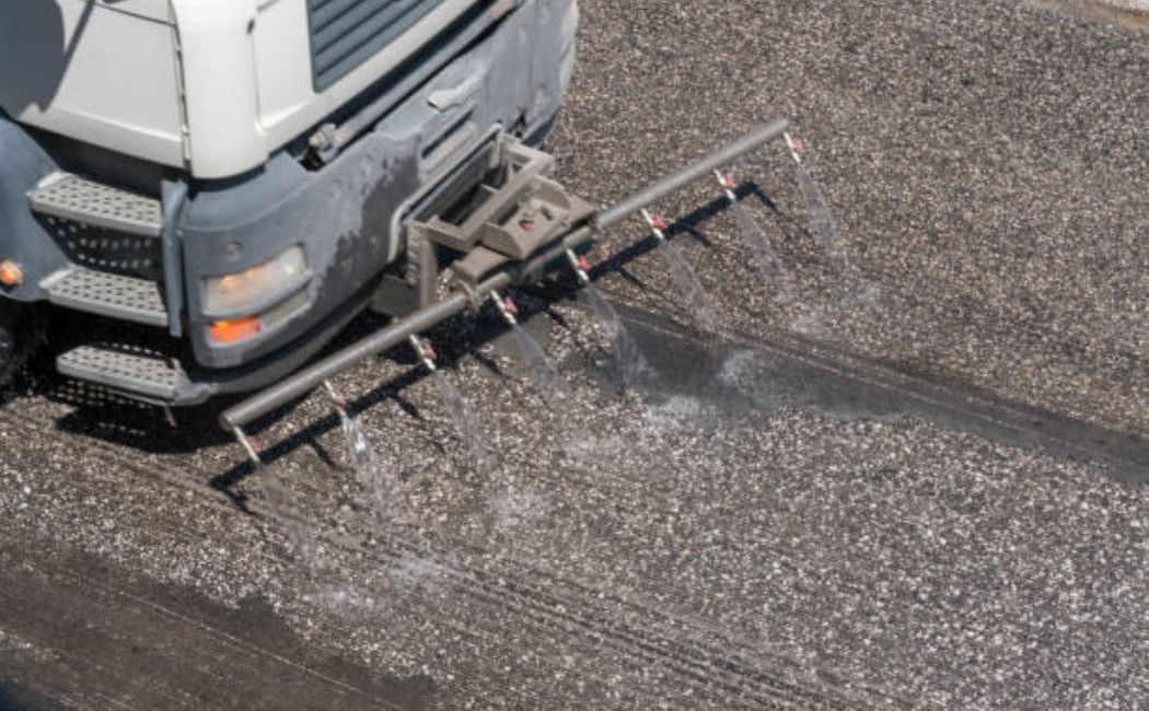 Road construction workers paving an asphalt road