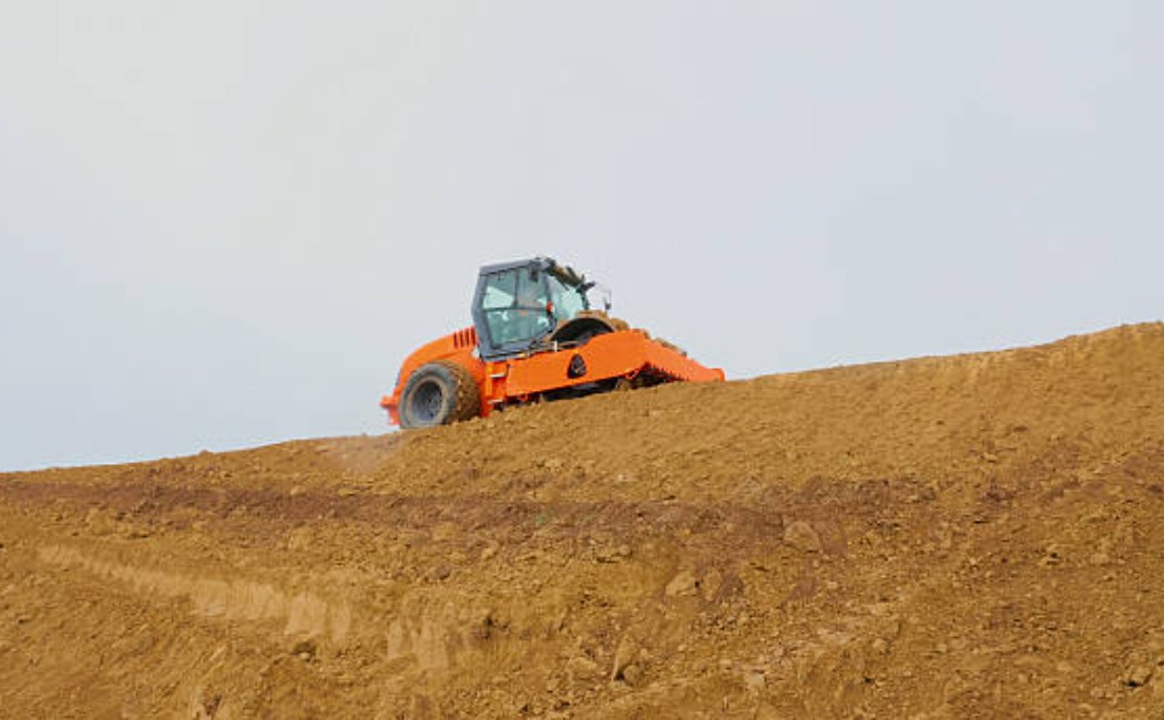 Industrial road roller working on land grading