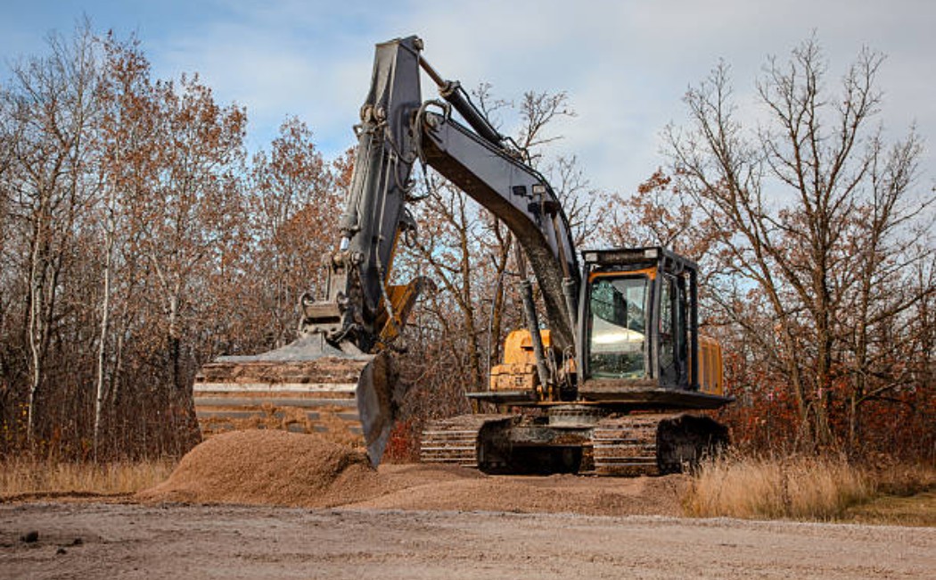 Workers moving gravel at a construction site