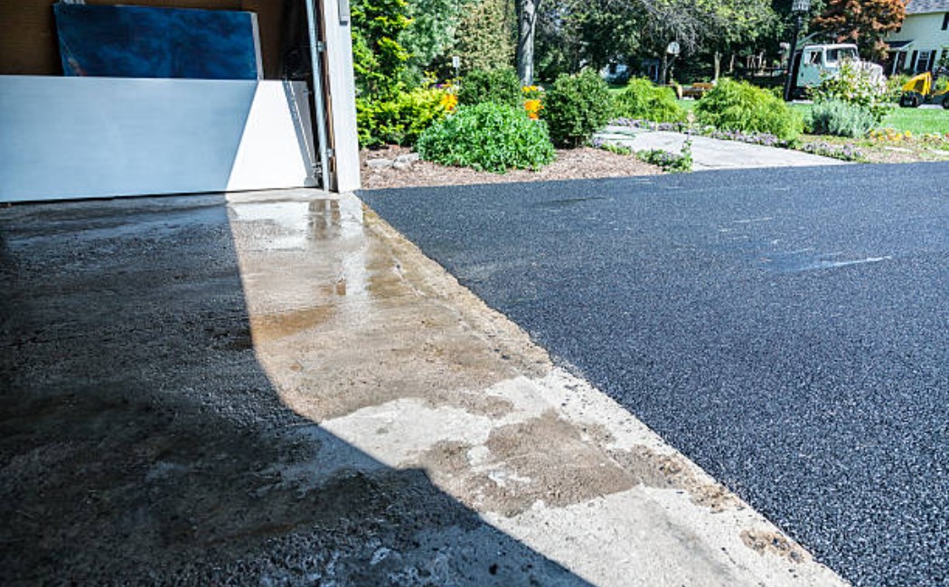 Asphalt leveling during driveway repair.