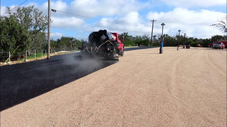 Professional Tar and Chip Seal application on a large parking lot, creating a durable, smooth, and long-lasting pavement surface.
