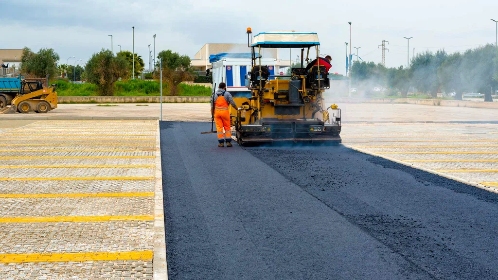 Asphalt Paving crew using a paving machine to install a smooth roadway surface.
