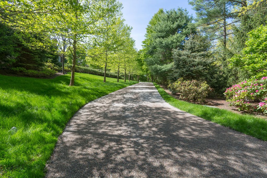 Chip Seal Driveway Services delivering a durable, attractive driveway that enhances curb appeal and complements the surrounding landscape.