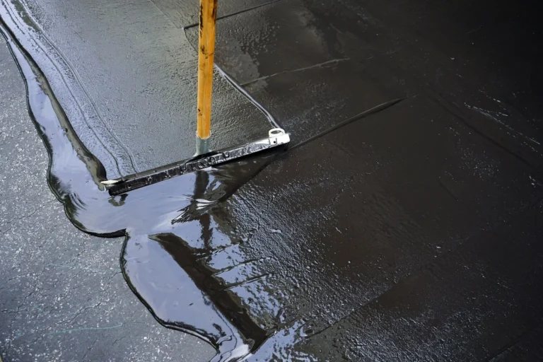 Seal Coating Services applying a protective asphalt layer for a smooth, durable, and weather-resistant surface.