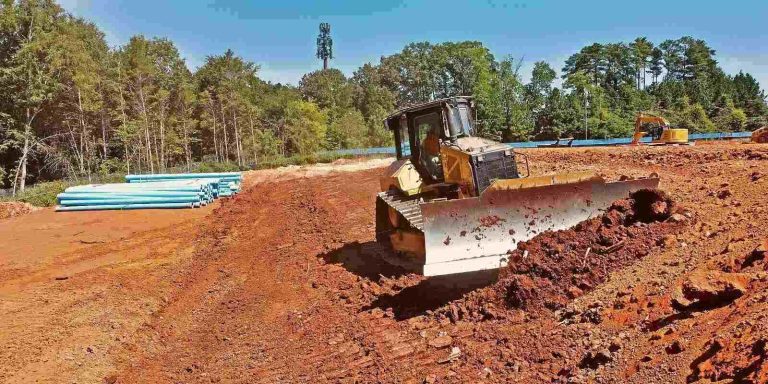 Professional Grading leveling ground with heavy equipment for a stable construction site.