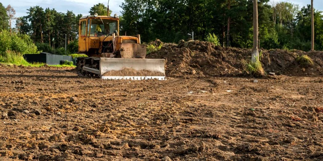 Professional Grading with Bulldozer for Site Preparation Professional Grading using a bulldozer to level and prepare soil for a stable construction site.